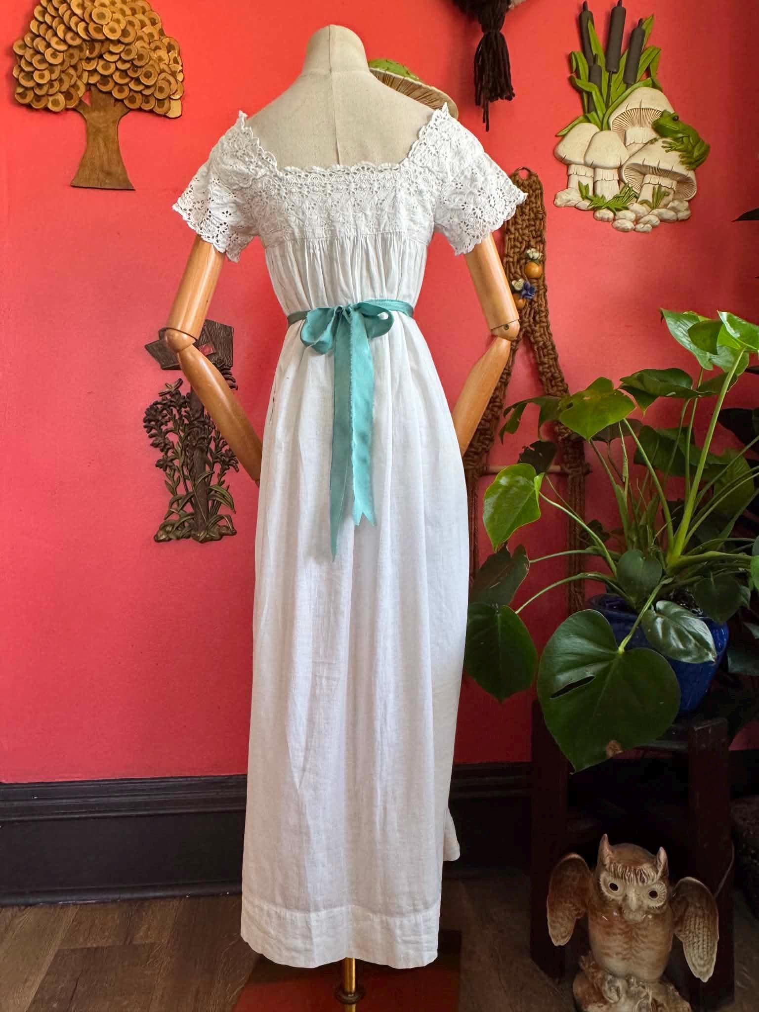 1900s white gown with lace details and blue ribbons., photo 1